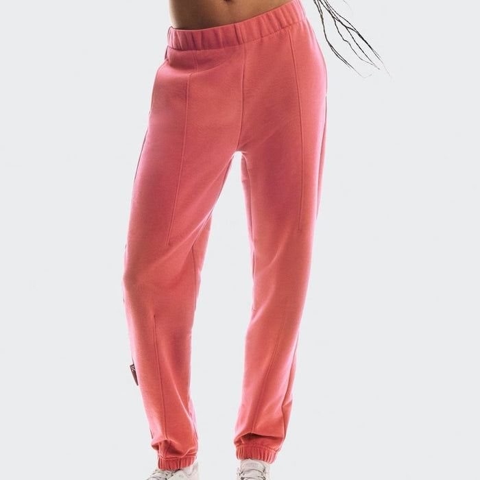On Cloud Women's Club Pants in coral, size XL, showing the relaxed fit and soft fabric of the stylish casual pants.