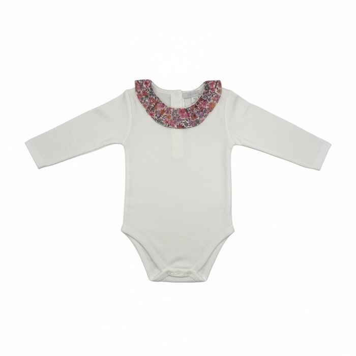 White baby onesie with a floral collar on a white background