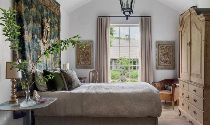 Patina Homes & Gardens book page: bedroom with bed, framed art, and window curtains