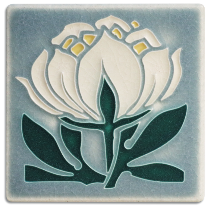 A handmade ceramic art tile featuring a grey and blue peony bloom design by Motawi in Ann Arbor, Michigan.