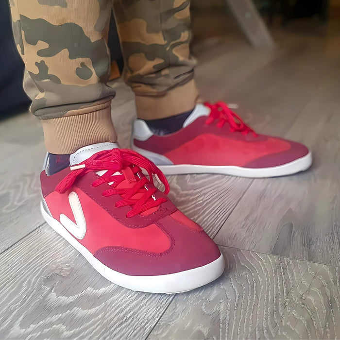 Close up of boy wearing red barefoot trainers