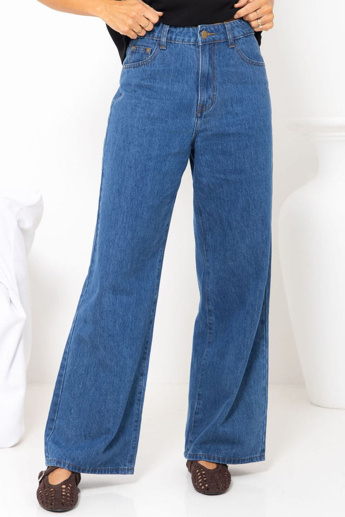 River wide-leg denim jeans in mid blue, high-waisted straight-leg jeans styled with a black t-shirt and woven leather flats