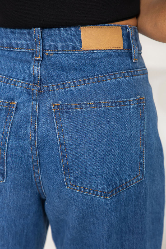 River wide-leg denim jeans in mid blue, high-waisted straight-leg jeans styled with a black t-shirt and woven leather flats
