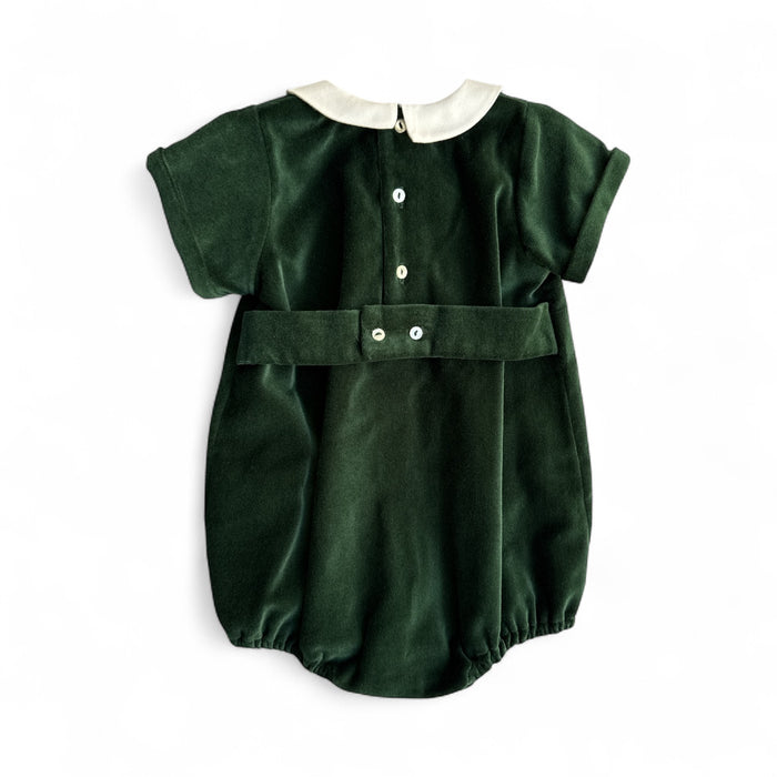 Green baby romper with white collar on a white background