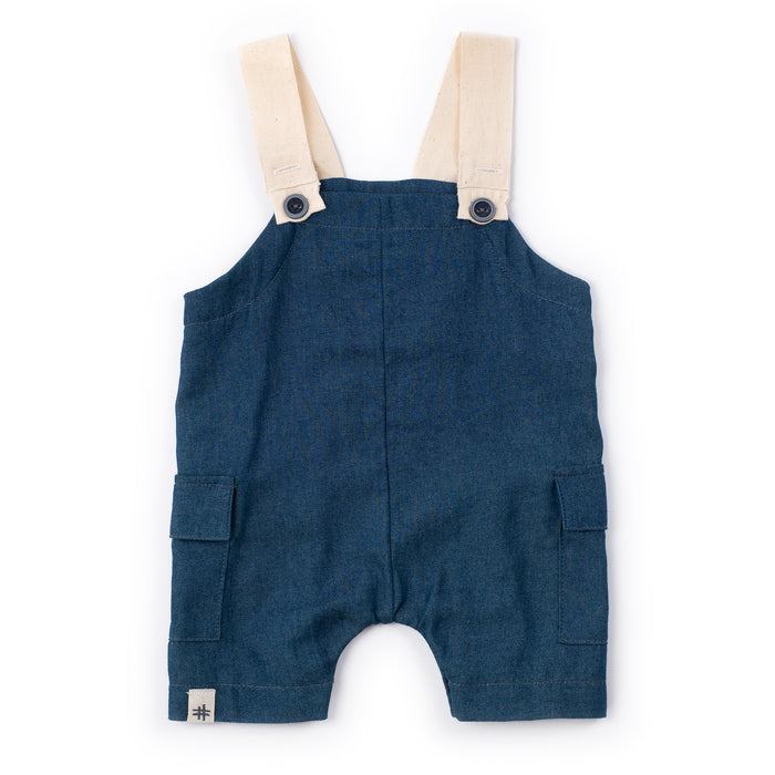 Blue denim overalls with beige straps on a white background