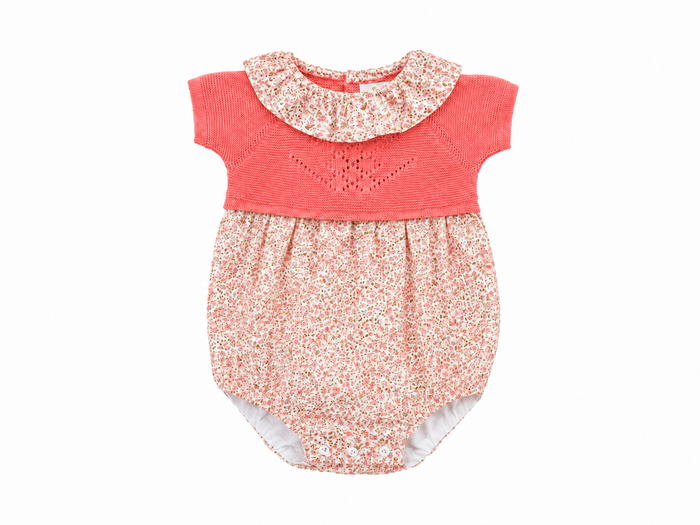 Baby romper with floral collar and bottom on a white background