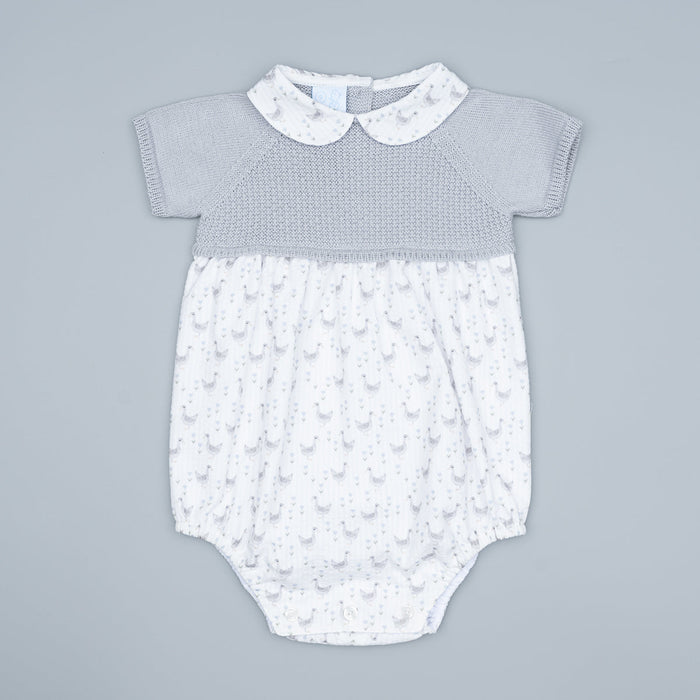 Baby romper with duck pattern on a gray background