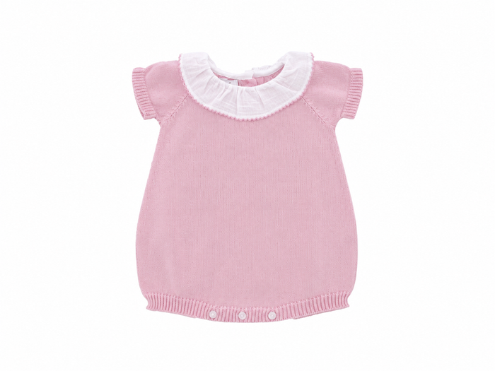 Pink knitted baby dress with white collar on a white background