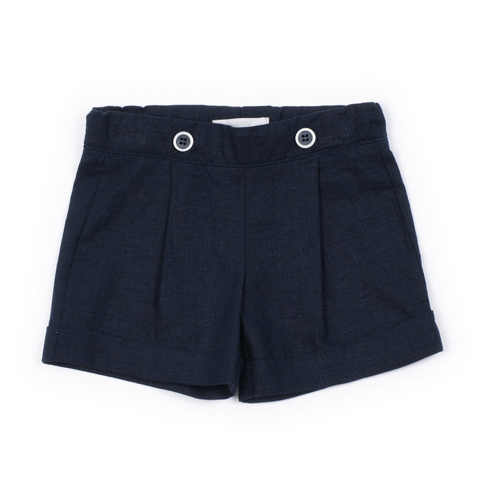 Navy pleated shorts with button details on a white background