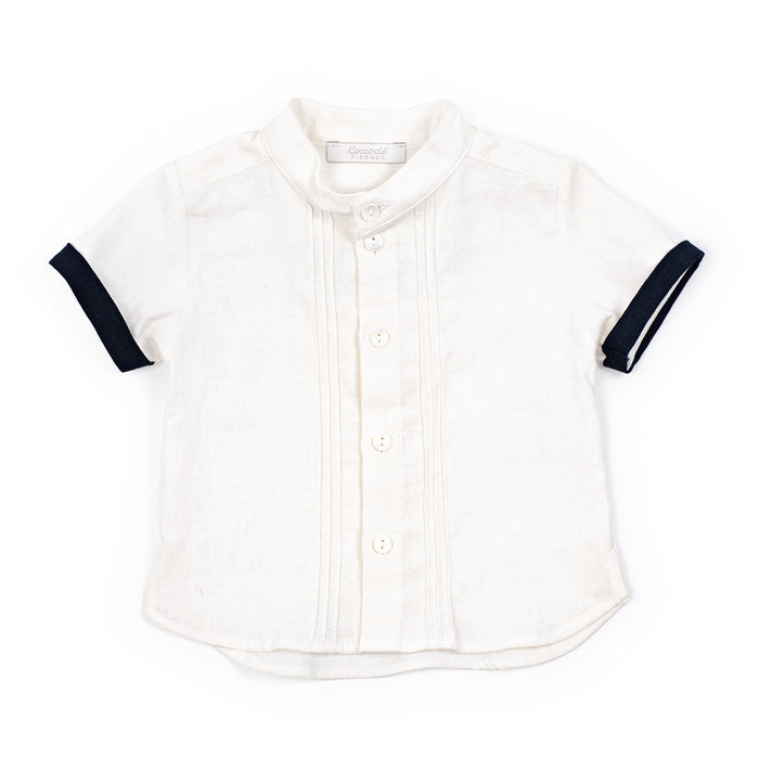 White shirt with navy accents on sleeves and collar against a white background