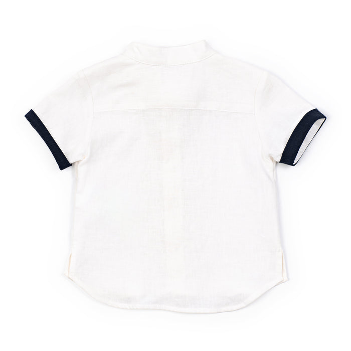White tank top with navy straps on a white background
