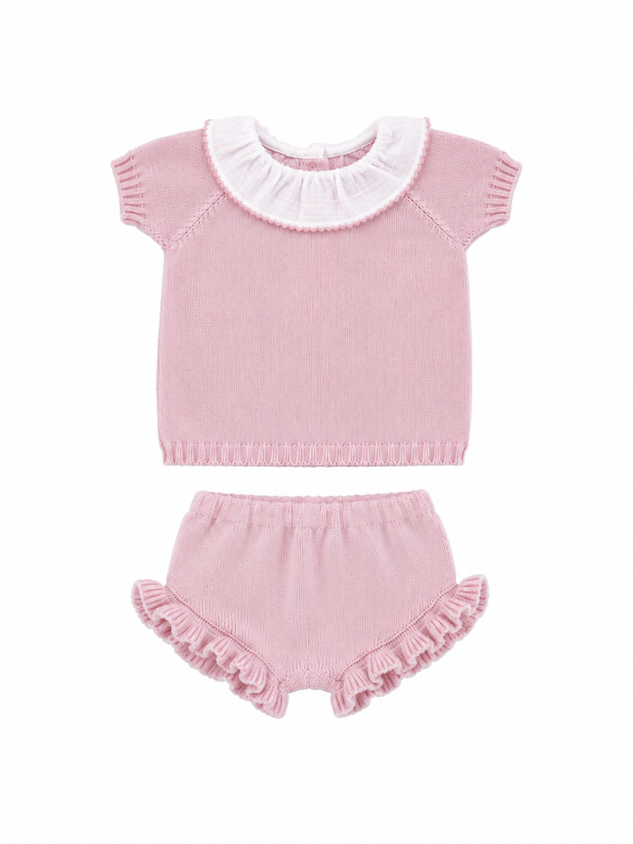 Pink baby outfit with ruffled collar and bloomers on a white background