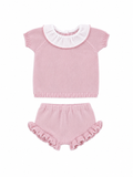 Pink baby outfit with ruffled collar and bloomers on a white background