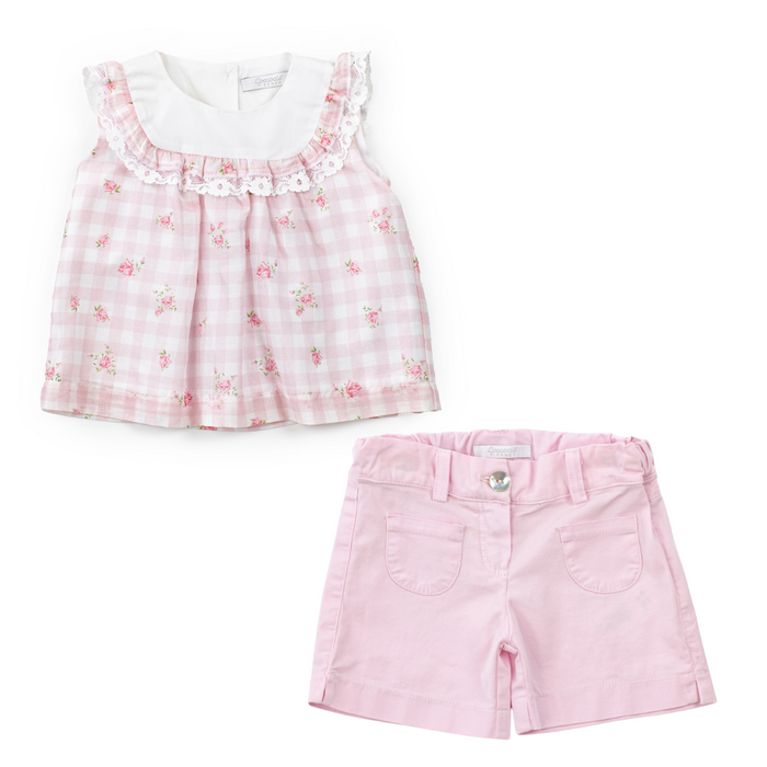 Children's outfit with pink floral top and shorts on a white background