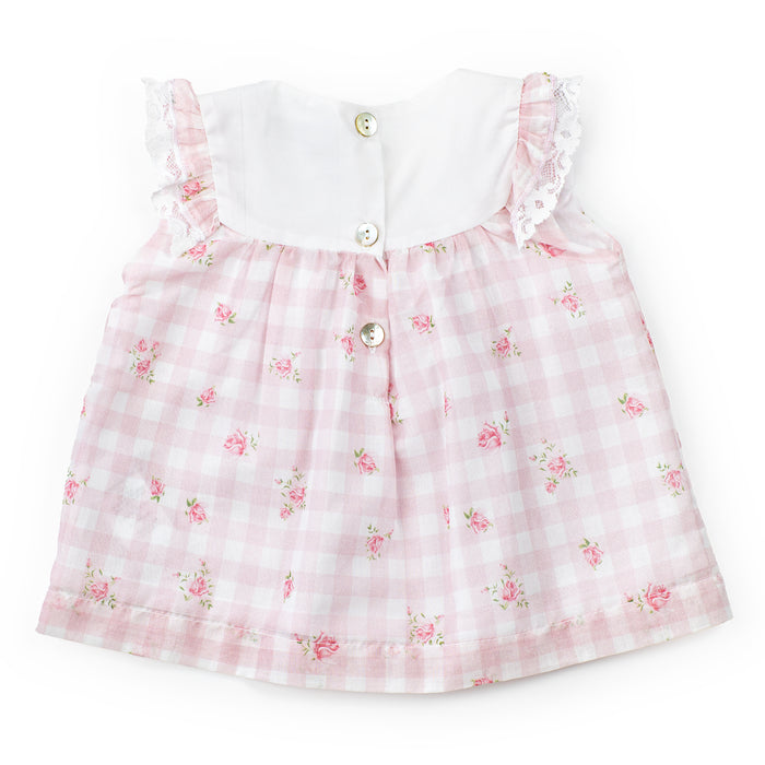Pink checkered dress with floral patterns on a white background