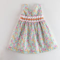 Floral dress with ruffled details on a light gray background