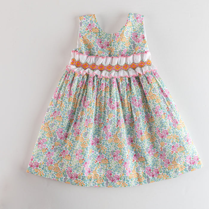 Floral dress with ruffled details on a light gray background