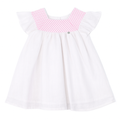 White dress with pink smock neckline on a white background by coccode