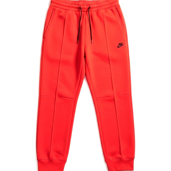 Nike Sportswear Tech Fleece Joggers for women in orange, XS size, showing the comfortable fleece fabric and athletic fit.