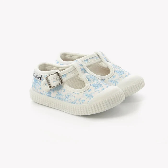 Pair of children's shoes with floral pattern on a white background