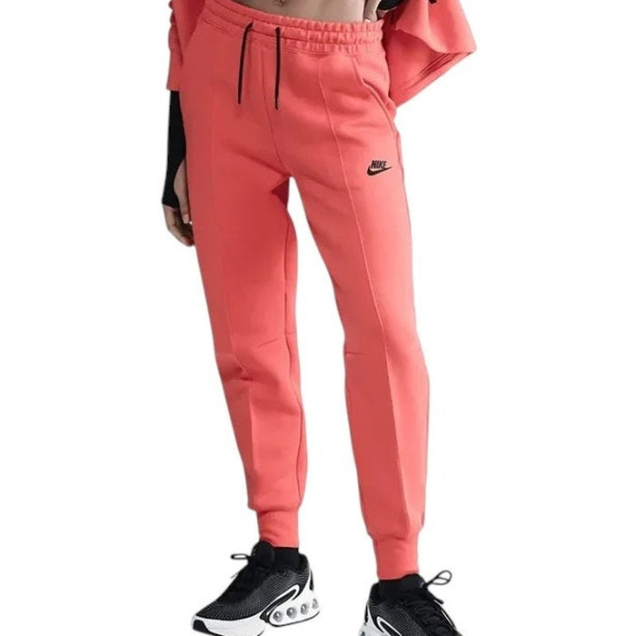 Women's Nike Tech Fleece Jogger Pants in mid-rise fit, medium size, featuring a comfortable, tapered design and Nike branding.