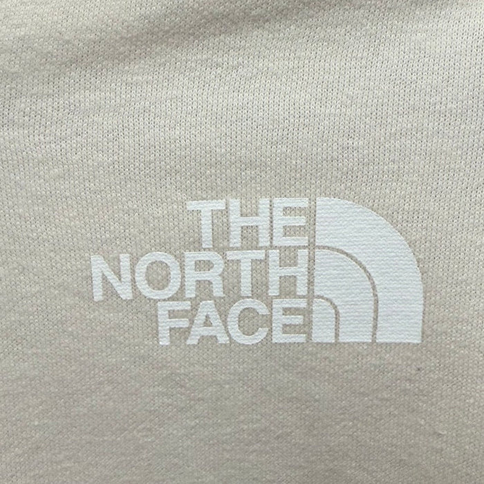 The North Face women's full-zip hoodie in Gardenia White, featuring a hood, front pockets, and The North Face logo.