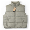 Nike Therma-FIT women's puffer vest in light army color, lightweight jacket with quilted design and stand collar.