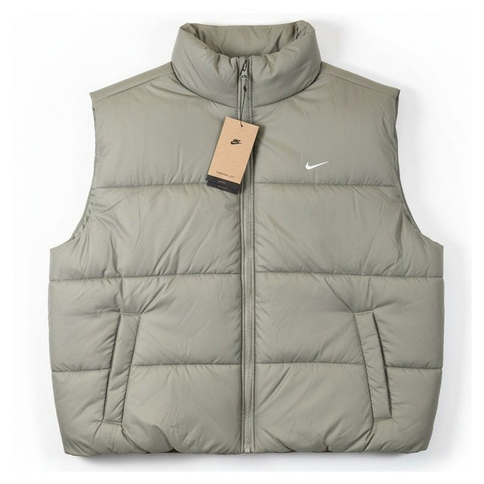 Nike Therma-FIT women's puffer vest in light army color, lightweight jacket with quilted design and stand collar.