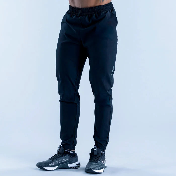Dark training jogger pants with elastic waistband and tapered legs, ankle cuffs