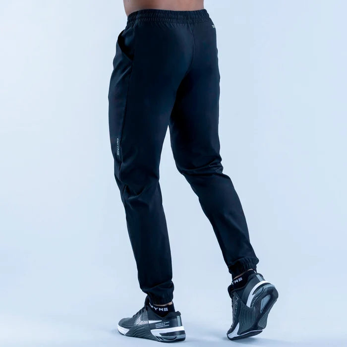 Dark training jogger pants from side view, elastic waistband and tapered fit