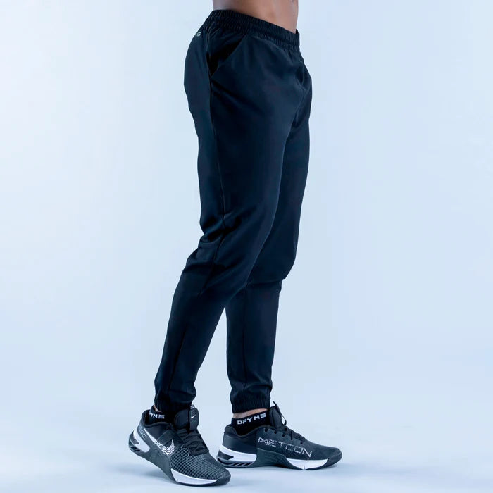 Dark training jogger pants back view, elastic waistband and tapered legs