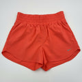Nike women's high-waisted Dri-FIT training shorts in coral, size XL, laid flat showing soft fabric and elastic waistband.