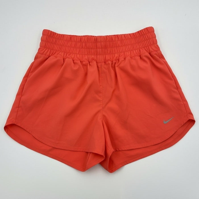 Nike women's high-waisted Dri-FIT training shorts in coral, size XL, laid flat showing soft fabric and elastic waistband.