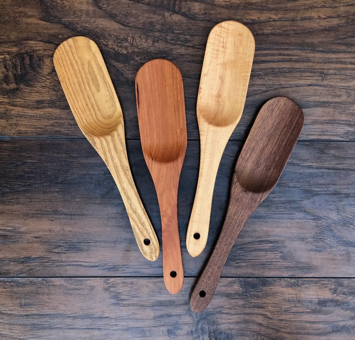 Set of four wooden spoonula spatulas with rounded heads and hanging holes