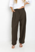 Xavier pants in dark olive brown – high-waisted, wide-leg trousers with pleated front, worn with a white cropped tee and thong sandals